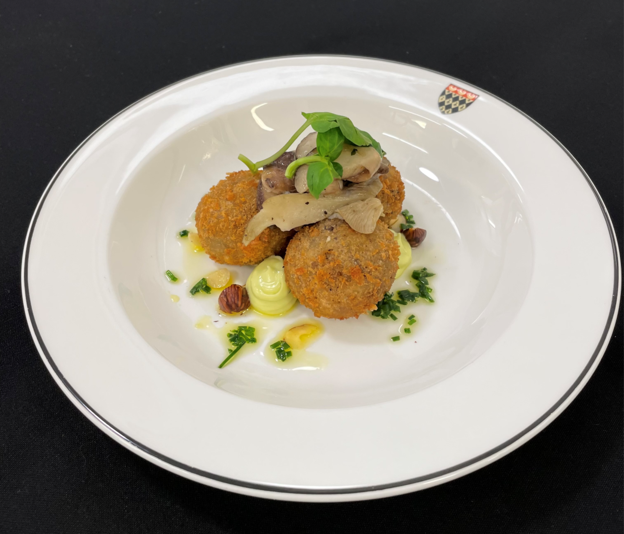 Wild mushroom and mozzarella arancini (v) served with parsley mayonnaise, micro herbs and hazelnuts