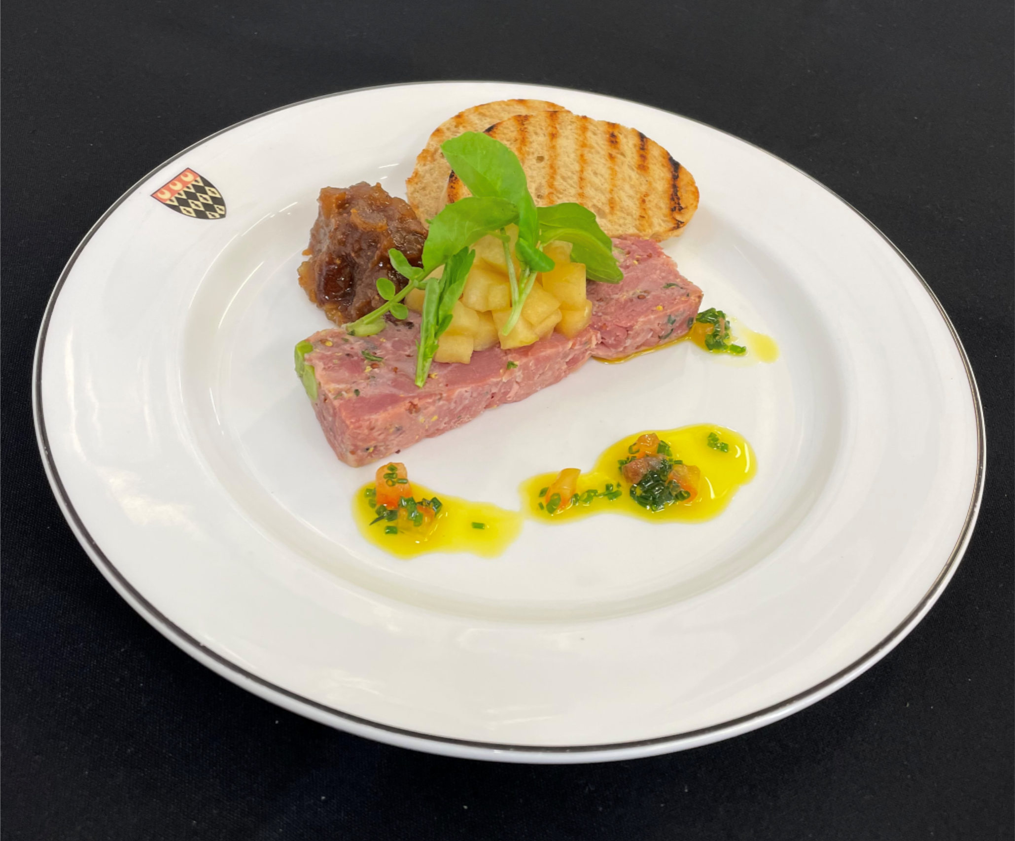 Pressed ham hock with pea shoots served with a caramelised apple salad and sourdough croute